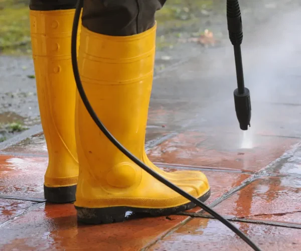 Pressure cleaning driveway to remove dirt, stains, and mould
